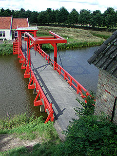 The lift portion of the drawbridge takes up less than half of the bridge causeway.  Note there are also a couple of meters of dry land bewtween the end of the bridge and the gate at the right.